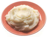 rose-colored plate of mashed potatoes filling the plate
